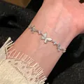Elegant silver-tone bracelet featuring sparkling zircon butterfly charms on wrist - Multiple Butterfly Pendant Style (S842) / Silver