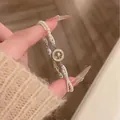 Elegant silver-tone pearl bracelet featuring a sparkling starburst zircon charm for women - Starry Ray Disk Artificial Pearl Style (S860金) / Gold