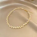 Elegant vintage gold wire wrapped pearl necklace displayed on luxurious champagne silk fabric - Winding Pearl Necklace Style (X1009金) / Gold