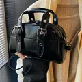 Elegant vintage glossy black handbag with silver-tone metal buckle details for women - Black