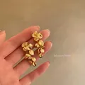 Elegant gold flower tassel drop earrings with vintage textured finish for women - Hammered Floral Tassel Style (A2188) / Gold