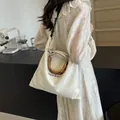 Elegant cream canvas tote bag featuring natural bamboo handles and long shoulder strap - Off White