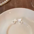 Clear heart-shaped silicone earring backs and stoppers displayed on a white plate. - Heart Support Style (ED001) / 1 Piece / White
