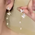 Elegant asymmetrical gold butterfly tassel earrings with white pearls for women - Shell Butterfly Tassel Style (A2280) / Gold
