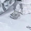 Close-up of sparkling four-leaf clover open ring paved with cubic zirconia stones - Cutout Clover Floral / Silver