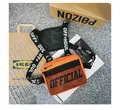 Detailed macro view of orange tactical chest bag with bold OFFICIAL print and straps - Orange