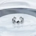 Close-up detail of a silver geometric open ring with shimmering pavé-set stones. - Style 6 Geometric Wave / Adjustable Open