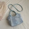 Stylish small denim blue bucket bag featuring top handle and adjustable crossbody strap - Without Pendant / Blue