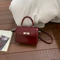 Elegant wine red leather crossbody handbag with a top handle and silver twist lock metal clasp - Standard Type / Red