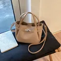 Vintage beige pebbled leather bucket bag with silver turn-lock and shoulder strap - Khaki No Charm