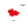 Side view of a 3D printed red triceratops dinosaur toy, 5.5cm long. - Red