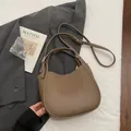 Elegant brown pebbled leather hobo handbag with top handles and adjustable strap - Gray
