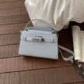 Elegant light blue mini crossbody bag featuring crocodile texture and silver buckle - No Pendant / Blue