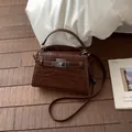 Elegant brown crocodile pattern crossbody handbag featuring a silver metal turn-lock clasp - No Pendant / Brown