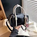 Elegant black and white mini pillow handbag featuring a shoulder strap and cute bear charm. - Black With Rabbit Pendant