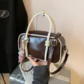 Elegant mini dark brown pillow handbag with white top handles and adjustable strap - Coffee With Rabbit Pendant
