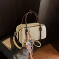 Stylish mini cream and brown pillow handbag with cute dog charm and adjustable strap - White And Brown With Charm