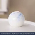 Minimalist white ceramic vase with blue crystalline glaze, 9.5cm diameter SKU variant - White Base Blue Floral Sphere / Diameter 9.5cm x Height 8.5cm x Caliber 2.8cm