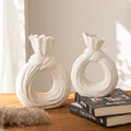 Two modern white ceramic vases with bag shape design on wooden desk - New Knotted Large And Medium Set / Two-Piece Set