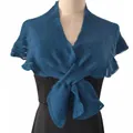 Detail of blue knitted shrug shawl wrapped over a black evening dress on mannequin - Teal