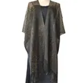 Detailed view of shimmering gold and silver thread shawl with elegant fringe trim - Black and Gold
