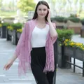 Elegant pink lace shawl with tassels worn by a model outdoors - Dusky Pink