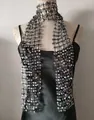 Detail view of black mesh scarf with sparkling silver sequins for glamorous party wear. - Black + Silver
