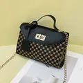 Elegant black flap crossbody bag featuring gold chain strap and geometric pattern - Black