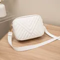 Modern white quilted crossbody camera bag featuring a stylish wide fabric strap - White