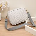 Premium light grey quilted camera bag featuring an adjustable wide fabric strap - Gray