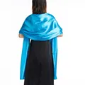 Back view of a shimmering blue satin shawl draped over an elegant black evening dress. - S / Lake Blue