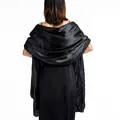Detail showing back drape of black satin shawl for evening dress with satin finish. - Black