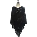 Detailed view of a black knitted crochet poncho with hollow patterns and tassel fringe - Tops / Black