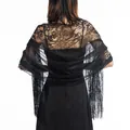 Detailed close-up of an elegant black lace shawl with floral patterns and fringes. - Black