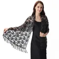 Detail of black sequined lace shawl with paisley pattern and elegant fringe trim - Black