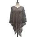 Close-up detail of a gray knitted poncho with intricate openwork patterns and fringe hem - Tops / Gray