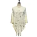 Detailed view of off-white knitted pullover poncho featuring geometric hollow pattern and tassels - Tops / White