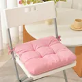Detailed view of a thick pink fabric seat cushion with ties on a white chair - 40*40cm / Pink