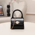 Elegant mini black crossbody bag featuring pearl button accent and gold chain strap - Black