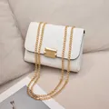 Elegant white quilted chain shoulder bag with stylish gold hardware and lock detail - White