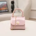 Stylish mini pink jelly crossbody bag featuring a pearl buckle and twisted top handle strap - Lotus Pink