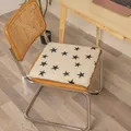 Square plush chair cushion with black star pattern shown on a wooden chair in office - Rabbit Plush Star Printed Style / 40x40cm Standard Type / White
