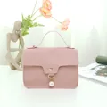 Elegant pink mini crossbody bag with top handle and pearl charm - Nappa Texture Pink