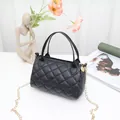 Stylish black quilted pillow handbag featuring gold chain strap and elegant top handles - Black