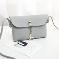 Grey minimalist mini crossbody phone bag with elegant gold deer pendant charm detail - Gray