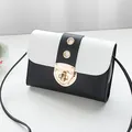 Small black and white color-block crossbody bag with gold lock and strap details - Black
