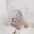Elegant pink shoulder bag featuring a geometric pattern and decorative floral silk scarf - Pink