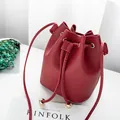 Elegant burgundy lychee grain drawstring bucket bag featuring premium gold hardware - Red