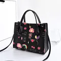 Fashionable black handbag with colorful cartoon prints and versatile shoulder strap - Cartoon Print / Black