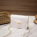 Elegant white textured crossbody bag with gold chain strap and classic square lock - White